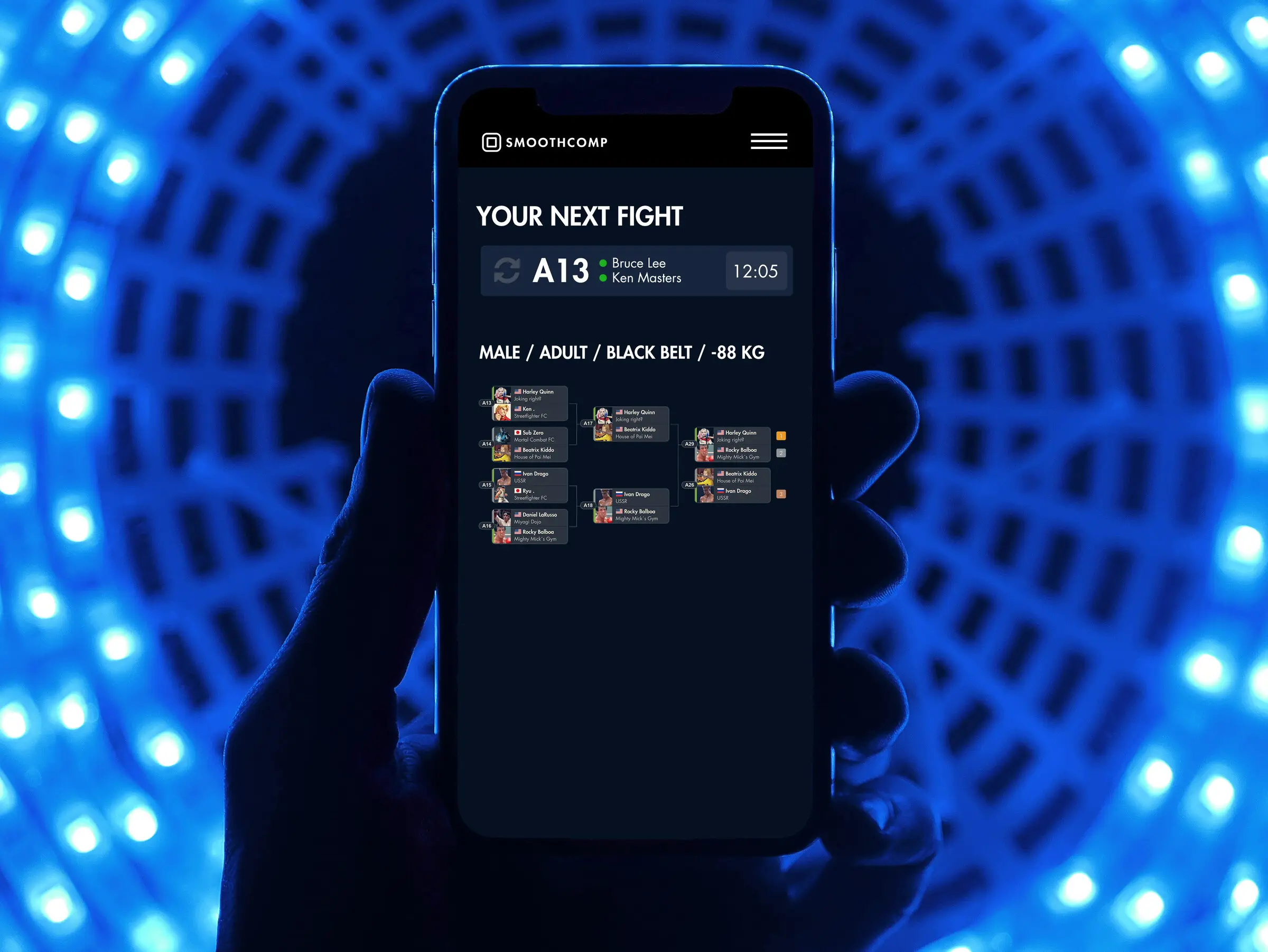 A phone showing the athlete's next fight on Smoothcomp, lit by a blue LED tunnel