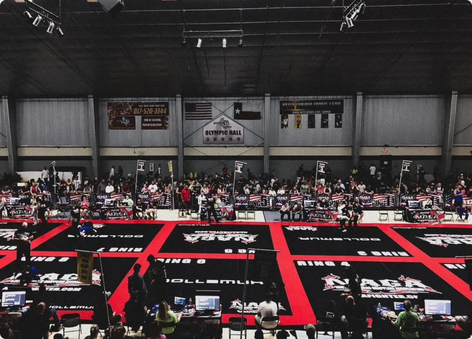 NAGA tournament hall with rows of red and black mats